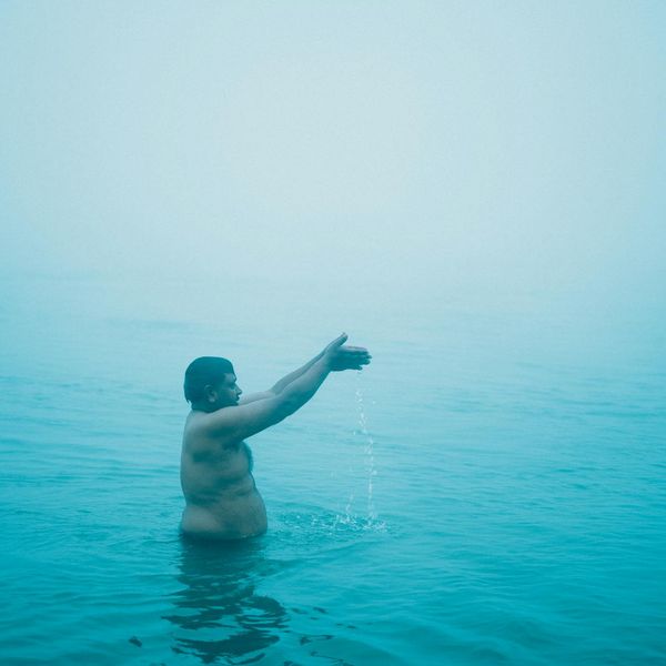 Silhouette of a man stretching at sunrise, symbolizing well-being and a fresh start.